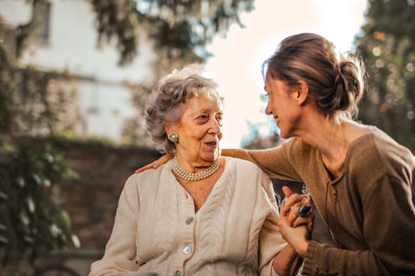 Senior resident receiving support at a day-care activity session